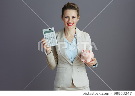 happy modern small business owner woman in light business suit 99963247