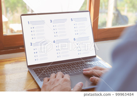Questionnaire online with checkboxes. A man passing online exam. Evaluation, Online survey online exam Choosing the right answer in the exam, Test questions. Filling out online survey form business. Questionnaire online with checkboxes. A man passing online exam. Evaluation, Online survey online exam Choosing the right answer in the exam, Test questions. Filling out online survey form business. 99963484