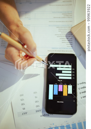 Business owner woman working with documents and studying charts Business owner woman working with documents and studying charts 99963922