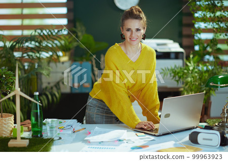smiling stylish business owner woman in green office standing smiling stylish business owner woman in green office standing 99963923