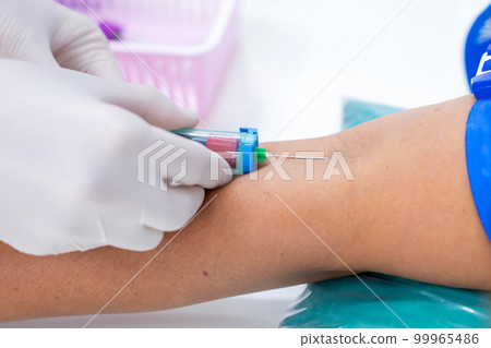 Nurse collecting a blood from patient in hospital 99965486