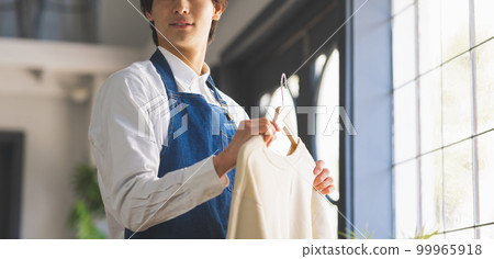 Male clerk with clothing Male clerk with clothing 99965918