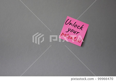 Unlock your Potential symbol. Concept words Unlock your Potential on pink steaky note. Beautiful grey background. Business and Unlock your Potential concept. Copy space. 99966470