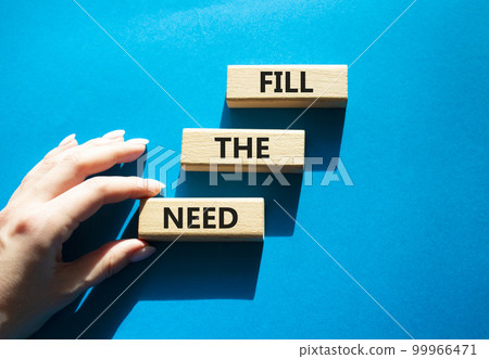 Fill the need symbol. Concept word Fill the need on wooden blocks. Beautiful blue background. Businessman hand. Business and Fill the need concept. Copy space 99966471