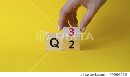 From 2nd Quarter to 3rd symbol. Businessman hand Turnes cube and changes words 2nd Quarter to 3rd Quarter. Beautiful yellow background. Business and Quarter concept. Copy space From 2nd Quarter to 3rd symbol. Businessman hand Turnes cube and changes words 2nd Quarter to 3rd Quarter. Beautiful yellow background. Business and Quarter concept. Copy space 99966989