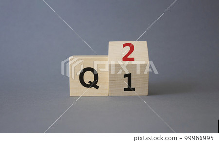 From 1st Quarter to 2nd symbol. Turned wooden cubes with words 1st Quarter and 2nd Quarter. Beautiful grey background. Business and Quarter concept. Copy space 99966995