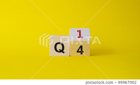 From 4th Quarter to 1st symbol. Turned wooden cube with words 4th Quarter and 1st Quarter. Beautiful yellow background. Business and Quarter concept. Copy space From 4th Quarter to 1st symbol. Turned wooden cube with words 4th Quarter and 1st Quarter. Beautiful yellow background. Business and Quarter concept. Copy space 99967002