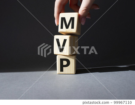 MVP - Most Valuable Player symbol. Wooden cubes with words MVP. Businessman hand. Beautiful grey background. Business and MVP concept. Copy space. MVP - Most Valuable Player symbol. Wooden cubes with words MVP. Businessman hand. Beautiful grey background. Business and MVP concept. Copy space. 99967110
