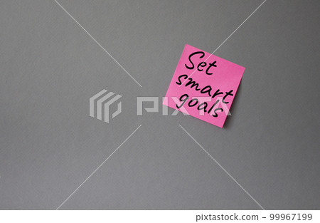 Set smart goals symbol. Concept words Set smart goals on pink steaky note. Beautiful grey background. Business and Set smart goals concept. Copy space. Set smart goals symbol. Concept words Set smart goals on pink steaky note. Beautiful grey background. Business and Set smart goals concept. Copy space. 99967199