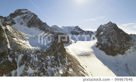 High snow capped mountains among large glaciers. 99967646