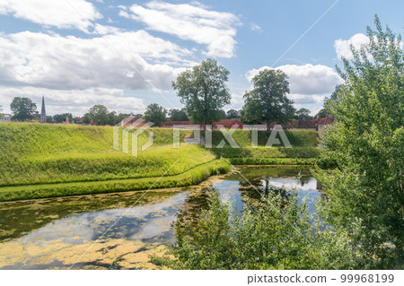 Moat along Kastellet fortress at summer time in Copenhagen, Denmark. Moat along Kastellet fortress at summer time in Copenhagen, Denmark. 99968199