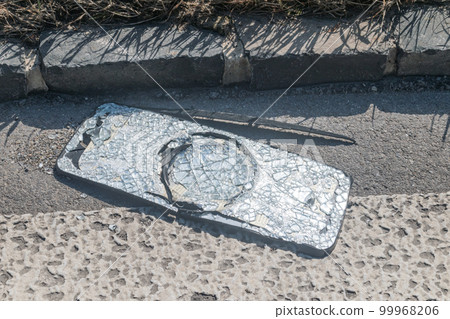 Broken truck side mirror on the street. 99968206