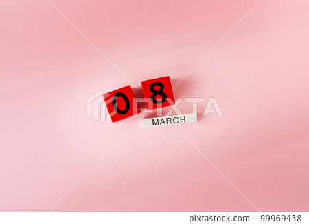 Wooden cubes with the inscription March 8 on a pink background, the inscription of a happy women's day. Ready card for the holiday, Women's Day. Wooden cubes with the inscription March 8 on a pink background, the inscription of a happy women's day. Ready card for the holiday, Women's Day. 99969438
