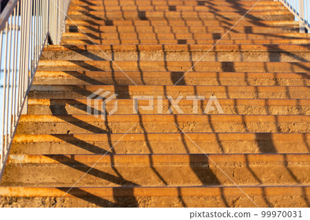 orange staircase with shadows from the handrails orange staircase with shadows from the handrails 99970031