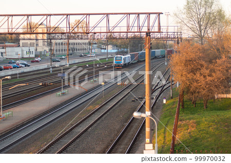 railway station with a lot of tracks and a moving train railway station with a lot of tracks and a moving train 99970032