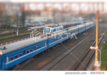 railway station with lots of tracks and moving trains 99970034