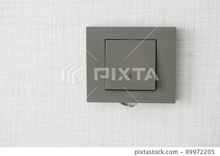 a lighting switch against white wall a lighting switch against white wall 99972205