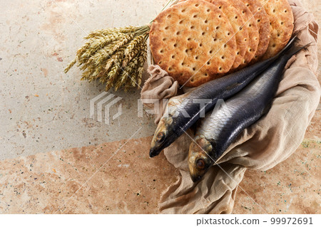 Catholic still life of five loaves of bread and two fish Catholic still life of five loaves of bread and two fish 99972691