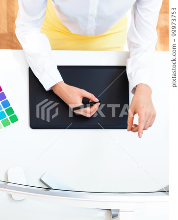 Graphic designer using her graphic tablet Graphic designer using her graphic tablet 99973753