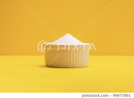 Natural organic sweetener Erythritol, produced by fermentation from corn, called dextrose in ceramic bowl on yellow orange background. Sugar substitute. Horizontal plane, copy space for text Natural organic sweetener Erythritol, produced by fermentation from corn, called dextrose in ceramic bowl on yellow orange background. Sugar substitute. Horizontal plane, copy space for text 99973901