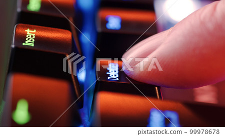 Human finger clicks on the Delete key on the computer keyboard, close up view. Man finger presses Delete on the keyboard key, macro shot. Rgb led light keyboard Human finger clicks on the Delete key on the computer keyboard, close up view. Man finger presses Delete on the keyboard key, macro shot. Rgb led light keyboard 99978678