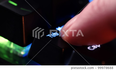 Human finger clicks on the Tab key on the computer keyboard, close up view. Man finger presses Tab on the keyboard key, macro shot. Rgb led light keyboard Human finger clicks on the Tab key on the computer keyboard, close up view. Man finger presses Tab on the keyboard key, macro shot. Rgb led light keyboard 99978688