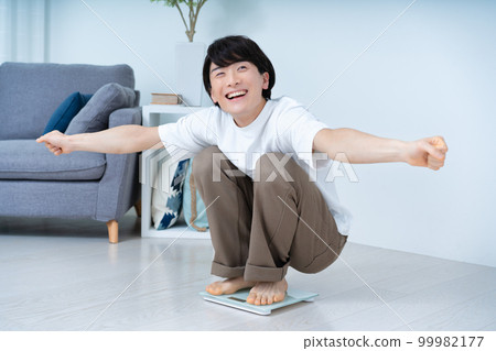 A man who is happy to measure his weight A man who is happy to measure his weight 99982177