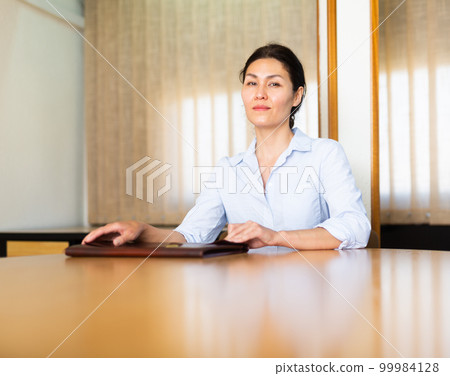 Portrait of young adult businesswoman at office Portrait of young adult businesswoman at office 99984128