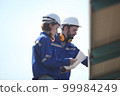 engineer working at solar farm 99984249