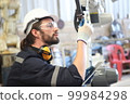 engineer checking auto parts in factory 99984298