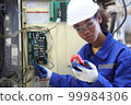 engineer checking auto parts in factory 99984306