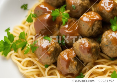 Spaghetti and swedish meatballs with parsley on white plate background close up 99984792
