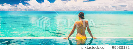 Hotel swimming pool luxury travel vacation summer holiday panoramic banner background with woman in bikini enjoyin sun tan swim lifestyle 99988381