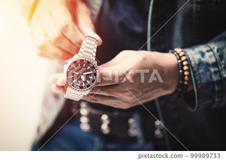 watch on wrist of man watch on wrist of man 99989733