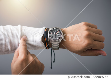 watch on wrist of man watch on wrist of man 99989736