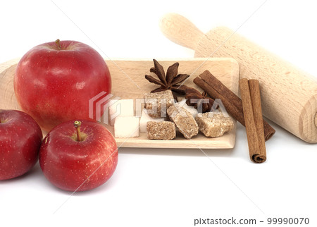 Apples, sugar, cinnamon sticks and anise stars near rolling pin Apples, sugar, cinnamon sticks and anise stars near rolling pin 99990070