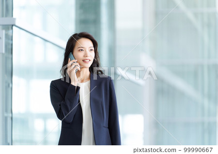 A woman in a suit to make a phone call A woman in a suit to make a phone call 99990667