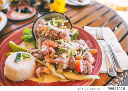 Tahiti food National dish local typical cuisine - Tahitian Raw Fish salad called Poisson Cru in French Polynesia. Top view of hotel restaurant meal in Bora Bora Tahiti food National dish local typical cuisine - Tahitian Raw Fish salad called Poisson Cru in French Polynesia. Top view of hotel restaurant meal in Bora Bora 99991926