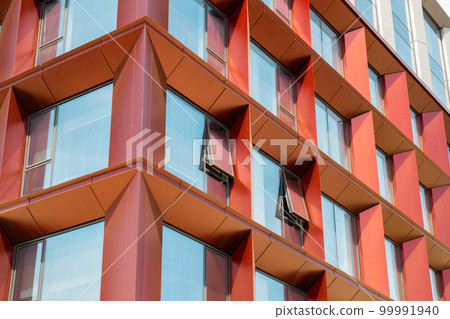 Modern office building exterior with glass facade on clear sky background. Transparent glass wall of office building with yellow decoration. Element of facade of modern European building Commercial Modern office building exterior with glass facade on clear sky background. Transparent glass wall of office building with yellow decoration. Element of facade of modern European building Commercial 99991940