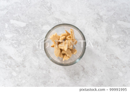 Flat lay. Soaking stale bread in milk to make meatloaf. 99991995