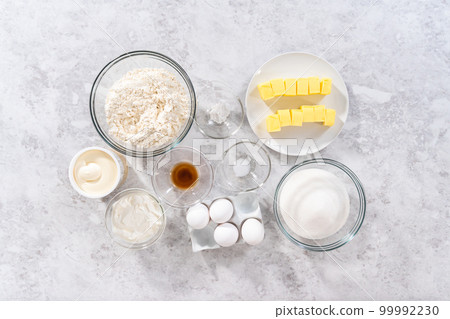Flat lay. Ingredients in glass mixing bowls to bake July 4th bundt cake with chocolate stars. Flat lay. Ingredients in glass mixing bowls to bake July 4th bundt cake with chocolate stars. 99992230