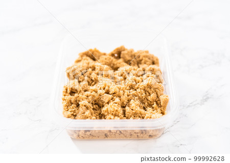 Light brown sugar on a marble counter top. 99992628