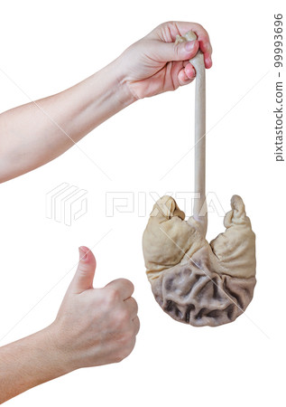 Hand holding pork stomach with thumb up isolated Hand holding pork stomach with thumb up isolated 99993696