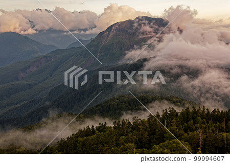 View of Mt. Yakedake from the ridgeline of Mt. Nishihotaka in the Northern Alps at dusk 99994607