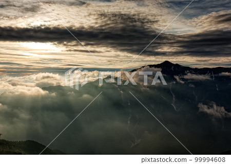 Mt.Kasagatake with the setting sun seen from the ridgeline of Mt. Nishihotaka in the Northern Alps 99994608