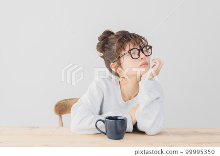 woman relaxing indoors woman relaxing indoors 99995350