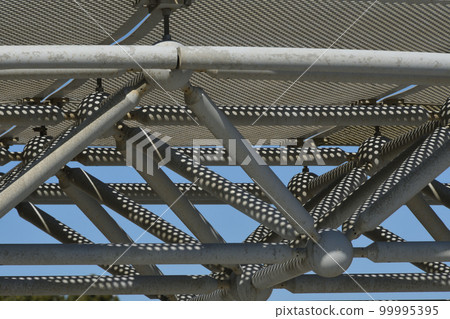 Shadow of perforated metal polka dots reflected on the truss 99995395