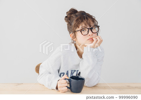 woman relaxing indoors woman relaxing indoors 99996090