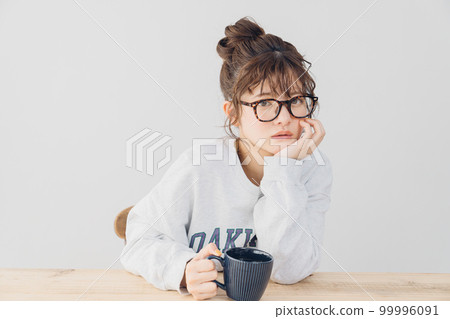woman relaxing indoors woman relaxing indoors 99996091