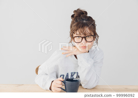 woman relaxing indoors woman relaxing indoors 99996092